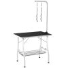 Dog grooming table with adjustable arms, mesh tray, two handles, and rubber surface